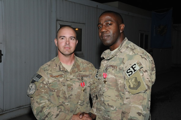 U.S. Air Force Tech. Sgts. Matthew Treadwell and Randy Sampson, both combat arms advisors for NATO Air Training Command  – Afghanistan, shake hands after being presented the Bronze Star with Valor. Treadwell is stationed at Altus Air Force Base, Okla., and Sampson is stationed at Travis Air Force Base, Calif. (Courtesy Photo)
