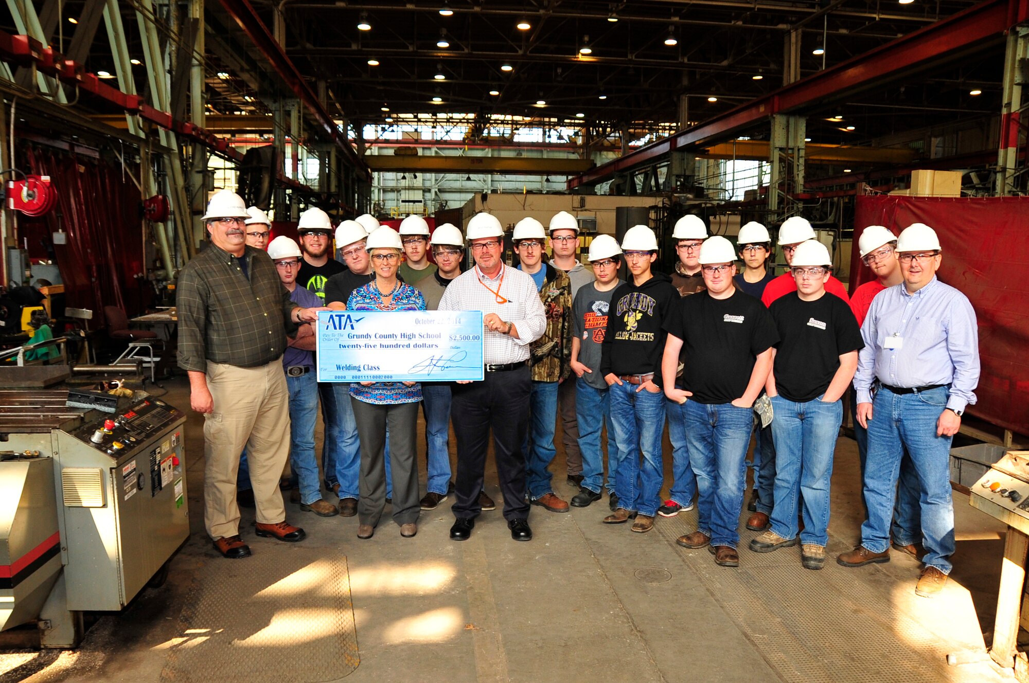 ATA Test Support Manager Walt Bishop (center) and Maintenance and Reliability Engineering Branch Manager David Hurst (far left) present Grundy County High School CTE Director Gina Sons (second from left), Welding Instructor Robin Dykes (far right) and students with a $2,500 donation for the school’s welding class. (Photo by Rick Goodfriend)