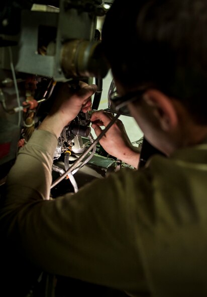 Senior Airman Jacob Jervell, 5th Maintenance Squadron air ground equipment journeyman, affixes safety wire to a cannon plug on a Dash 95 Air Source on Minot Air Force Base, N.D., Nov. 25, 2014. All parts not bolted in place on the air source must be held in place by safety wire. (U.S. Air Force photo/Senior Airman Stephanie Morris)