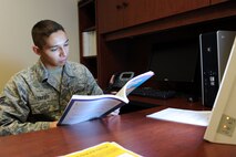 Airman 1st Class Seth Zarate, 28th Medical Operations Squadron mental health technician, works while receiving artificial light from a happy light at Ellsworth Air Force Base, S.D., Nov. 26, 2014. Happy lights are available for servicemembers to check out from both the Mental Health Clinic and the Health and Wellness Center for those who are affected by Seasonal Affective Disorder, a form of depression brought on during the fall and winter as a result of a reduced exposure to sunlight. (U.S. Air Force photo by Senior Airman Hailey R. Staker/Released)