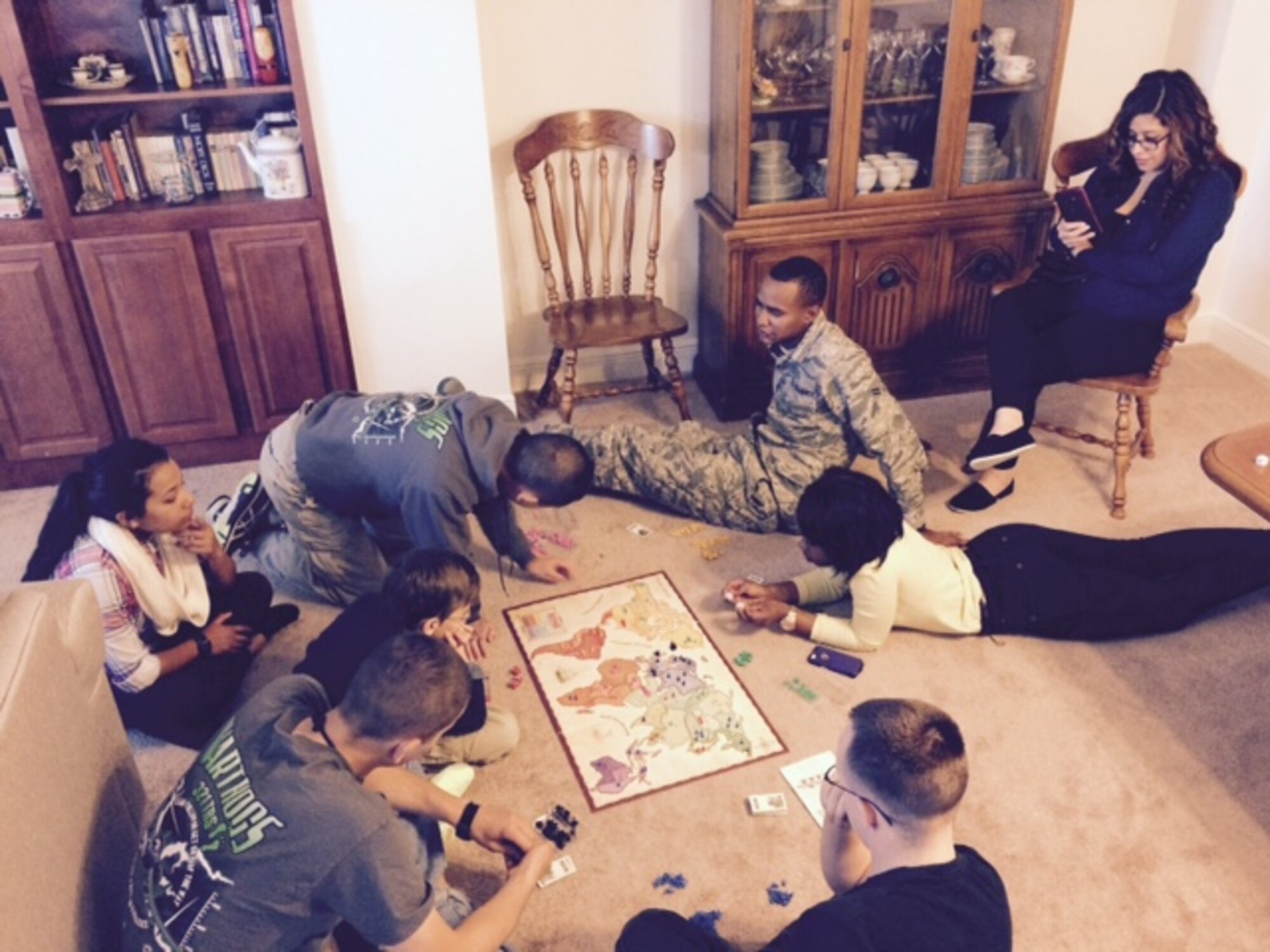Keesler Airmen play a board game at Chaplain (Col.) David Terrinoni’s house on Thanksgiving Day, Nov. 27, 2014. Terrinoni and his wife sponsored seven Airmen and two officers and their spouses from the 81st Training Group for the Home Away From Home program. A base tradition for 18 years, the program allows the Keesler community of active duty, retired and civil service personnel to host non-prior service Airmen in their homes to celebrate Thanksgiving Day. (Courtesy Photo)