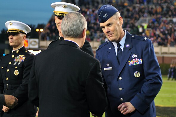Dr. Steve Ballard, East Carolina University chancellor, presents a coin to Col. Darrell Steele, 4th Maintenance Group commander, during ECU’s military appreciation day at Dowdy-Ficklen Stadium in Greenville, North Carolina, Nov. 22, 2014. Ballard offered a commemorative coin in appreciation for those serving in the armed forces. (U.S. Air Force photo/Senior Airman John Nieves Camacho)
