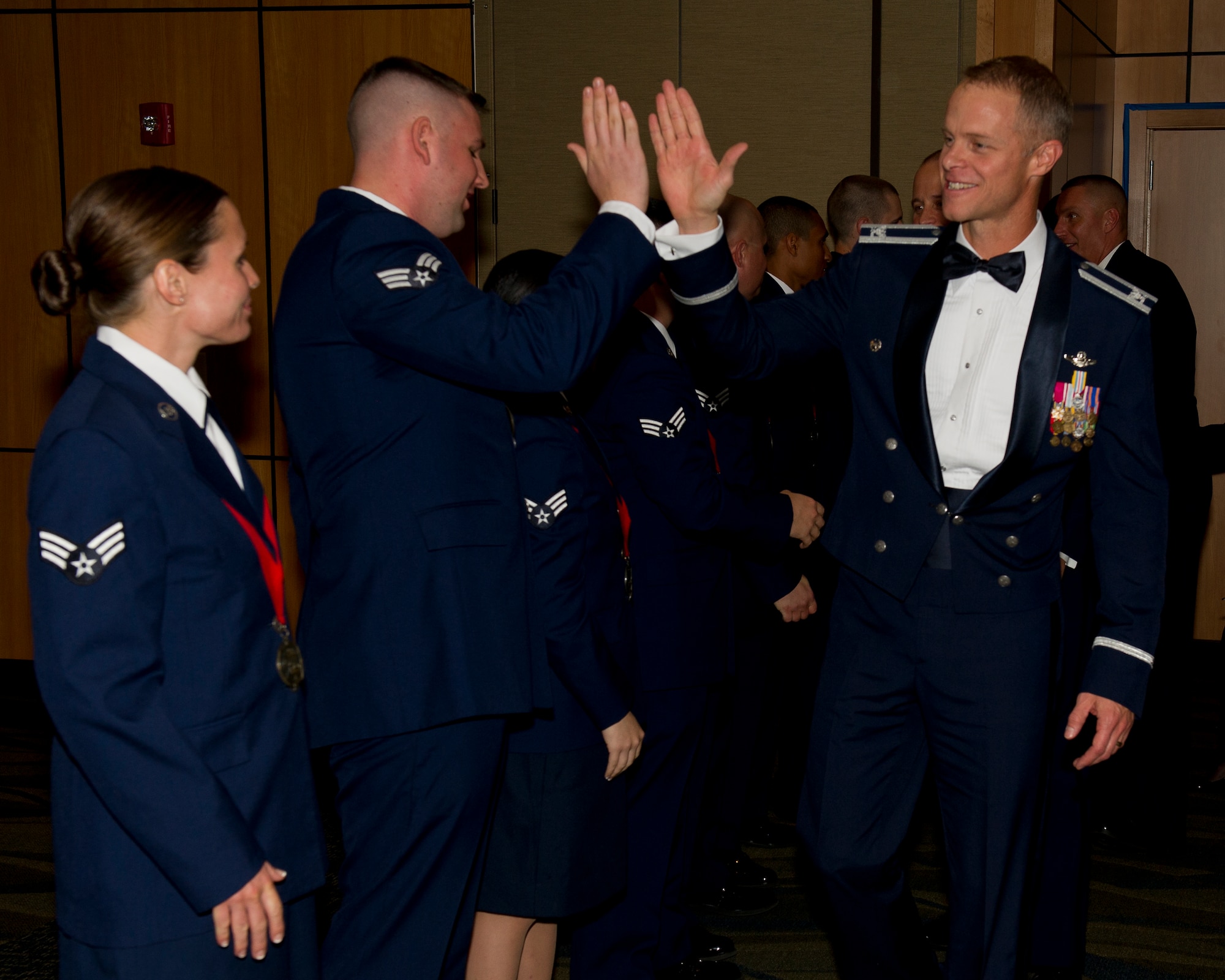 Colonel Derek C. France, 325th Fighter Wing commander, congratulates members of Advanced Leadership School class 15-1 after their graduation ceremony Nov. 25 at the Horizons Community Center. ALS is a five week-long Air Force program designed to develop Airmen into effective front-line supervisors. (U.S. Air Force photo by Airman 1st Class Alex Echols)