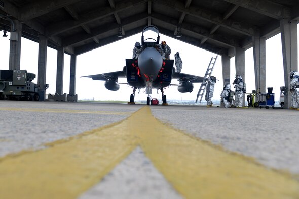 U.S. Air Force firefighters from the 18th Civil Engineer Squadron attempt to save a victim caught in the cockpit of an F-15C Eagle during a simulated aircraft fire as part of a mission focused exercise on Kadena Air Base, Japan, Dec. 1, 2014. The scenario was implemented to test Kadena's emergency responders on tactics and procedures in order to prepare them for potential real-world situations. (U.S. Air Force photo by Senior Airman Maeson L. Elleman/Released) 