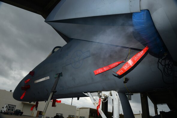 Smoke billows from a smoke machine installed in the intake of a U.S. Air Force F-15C Eagle during a simulated aircraft fire as part of a mission focused exercise on Kadena Air Base, Japan, Dec. 1, 2014. MFEs test Airmen on their ability to respond to emergency situations in order to better prepare them for future real-world situations. (U.S. Air Force photo by Senior Airman Maeson L. Elleman/Released) 