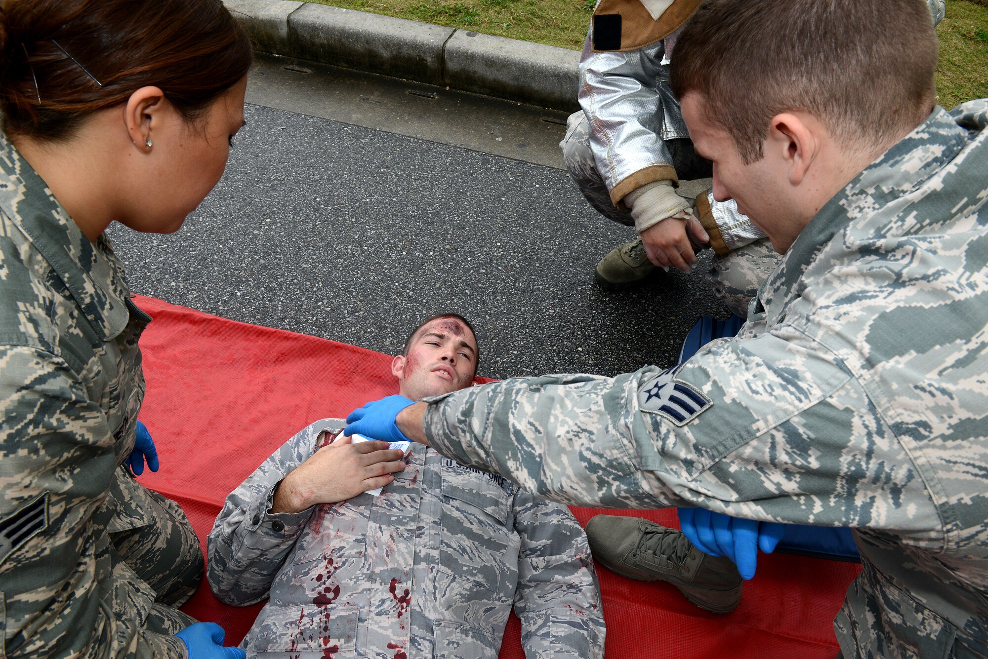 U.S. Air Force emergency responders treat a simulated victim during an active shooter scenario as part of a mission focused exercise on Kadena Air Base, Japan, Dec. 1, 2014. The active shooter exercise was one of many situations Airmen will be thrust into during the MFE, which is slated to run through Dec. 4. (U.S. Air Force photo by Senior Airman Maeson L. Elleman/Released)