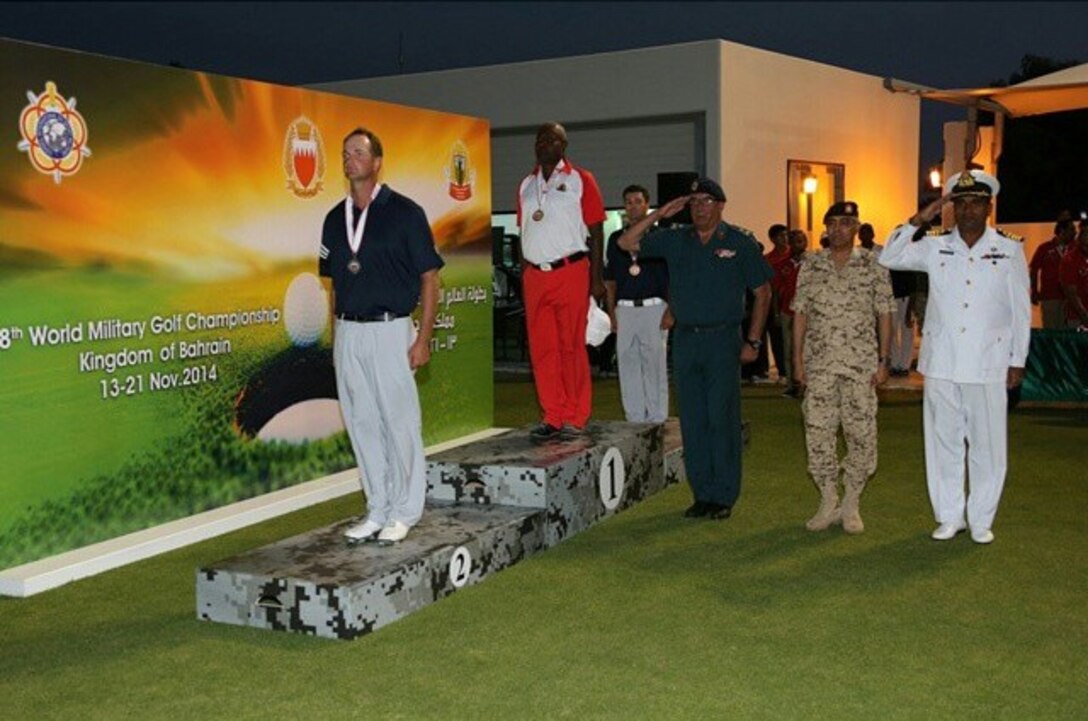Army Spec. Jordan-Tyler Massey (left) and Capt. Joseph Cave (second from left) win the CISM Men's silver and bronze respectively in the open division.  The US Men and Women Armed Forces Golf teams won respective gold medals for the seventh time during the 8th CISM World Military Golf Championship held in Bahrain 13-21 November 2014.