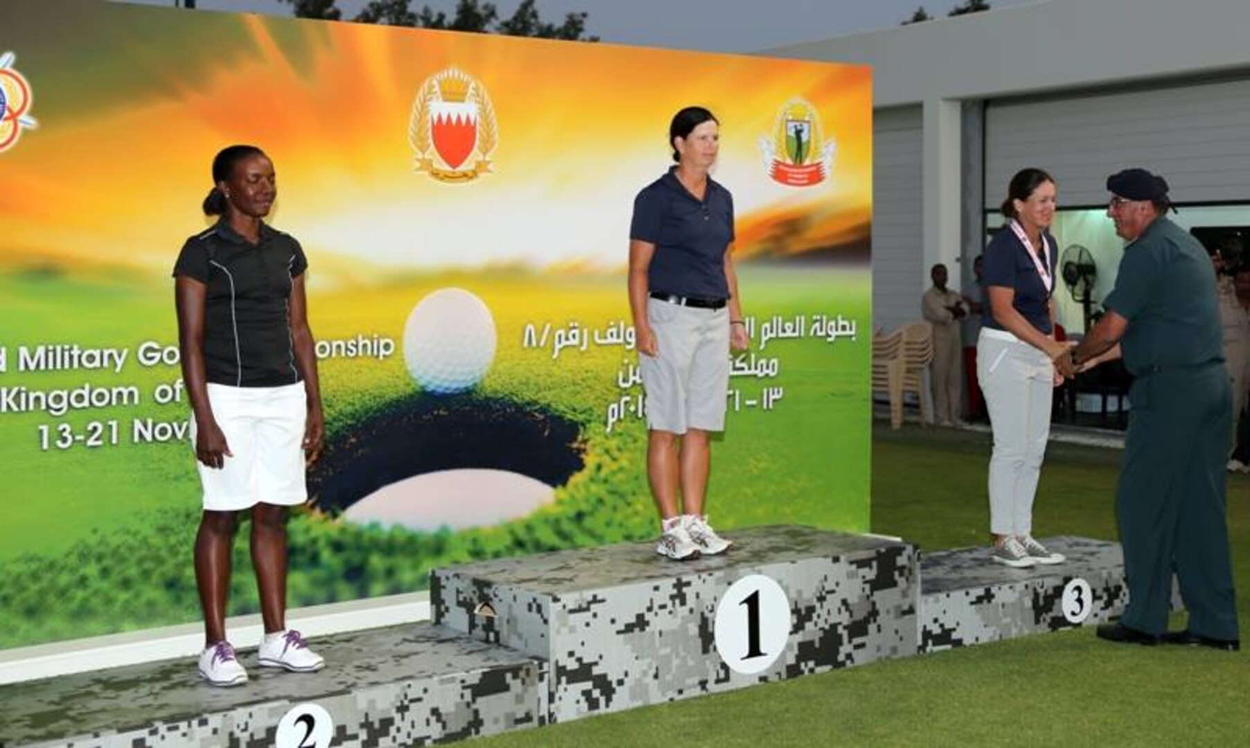 USAF Maj Linda Jeffery (center) and Navy LT Nicole Johnson (recieving her medal) win gold and bronze respectively.  The US Men and Women Armed Forces Golf teams won respective gold medals for the seventh time during the 8th CISM World Military Golf Championship held in Bahrain 13-21 November 2014.