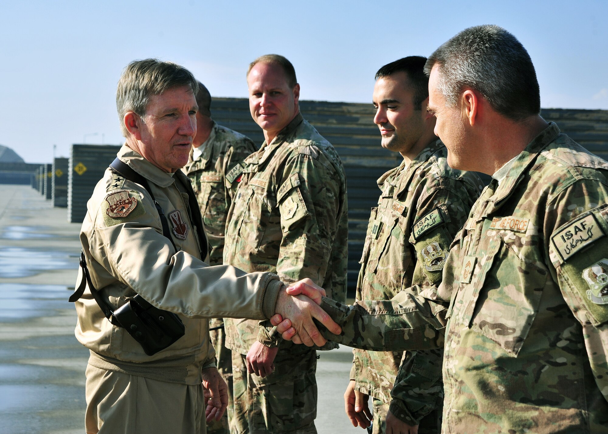 U.S. Air Force Gen. Hawk Carlisle, commander of Air Combat Command, shakes hands with members of the 455th Expeditionary Maintenance Group during a visit Nov. 27, 2014 at Bagram Airfield, Afghanistan. After an operations brief, Airmen demonstrated flightline defense procedures. (U.S. Air Force photo by Staff Sgt. Whitney Amstutz/released)