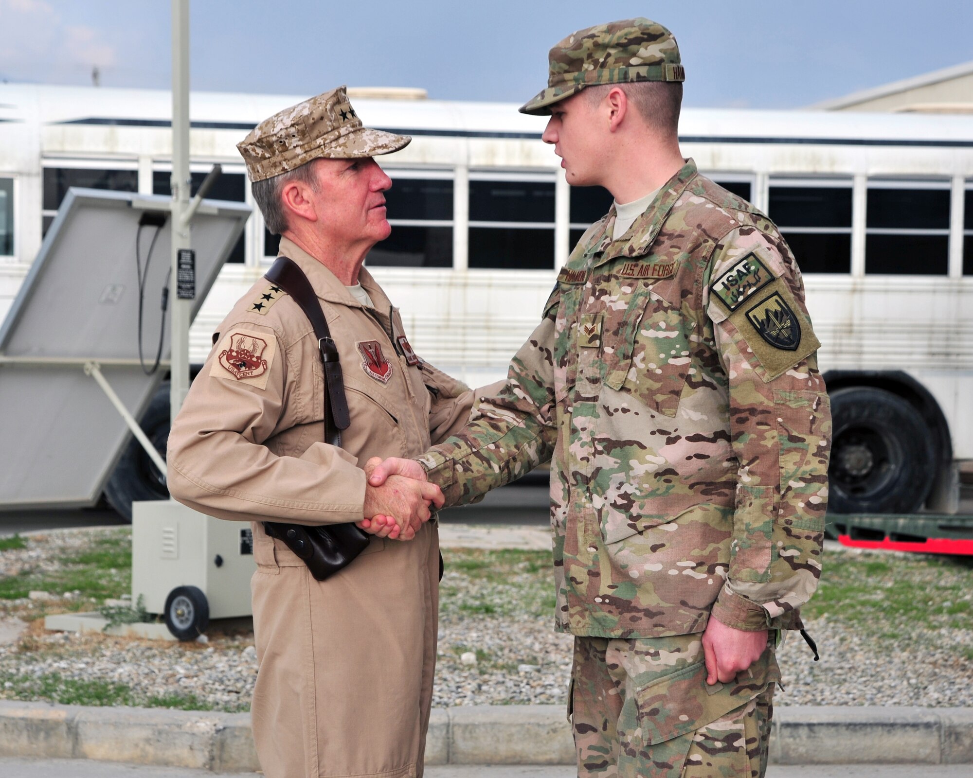 U.S. Air Force Gen. Hawk Carlisle, commander of Air Combat Command, greets Senior Airman Donald Hammonds, 455th Expeditionary Medical Operations Squadron, prior to being briefed on hospital capabilities Nov. 28, 2014 at Bagram Airfield, Afghanistan. Bagram Airfield's medical facility boasts a trauma room with equipment and capabilities comparable of those in continental United States. (U.S. Air Force photo by Staff Sgt. Whitney Amstutz/released)