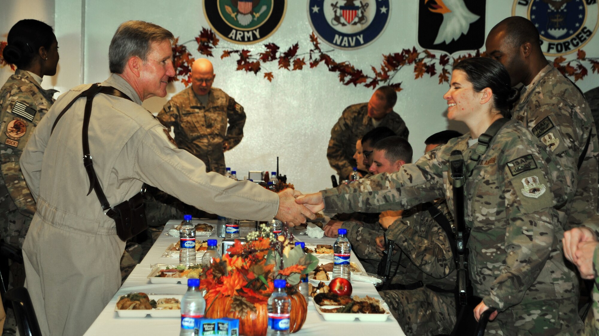 U.S. Air Force Gen. Hawk Carlisle, commander of Air Combat Command, welcomes Airmen during a Thanksgiving celebration Nov. 27, 2014 at Bagram Airfield, Afghanistan. During the dinner, Carlisle gave attendees the opportunity to ask questions, and expressed his gratitude for their sacrifices and dedication to duty. (U.S. Air Force photo/Staff Sgt. Whitney Amstutz/released)