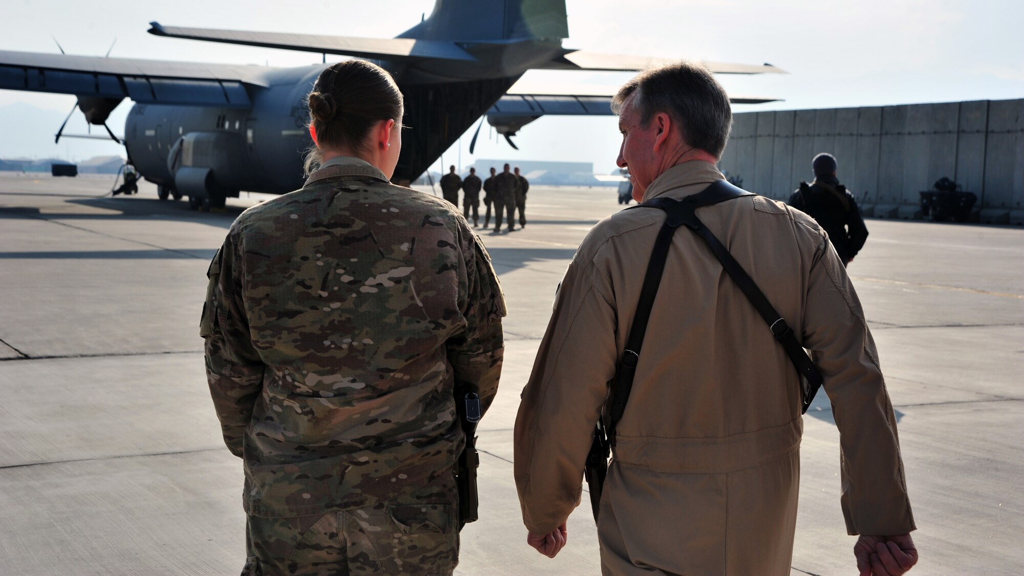 Senior Airman Ashley Osborne, 455th Expeditionary Aeromedical Evacuation Squadron, leads U.S. Air Force Gen. Hawk Carlisle, commander of Air Combat Command, across the flightline Nov. 28, 2014 at Bagram Airfield, Afghanistan. The 455 EAES is part of the 455th Expeditionary Operations Group, which oversees many of the daily combat and combat support operations conducted at the 455th Air Expeditionary Wing. (U.S. Air Force photo by Staff Sgt. Whitney Amstutz/released)  
