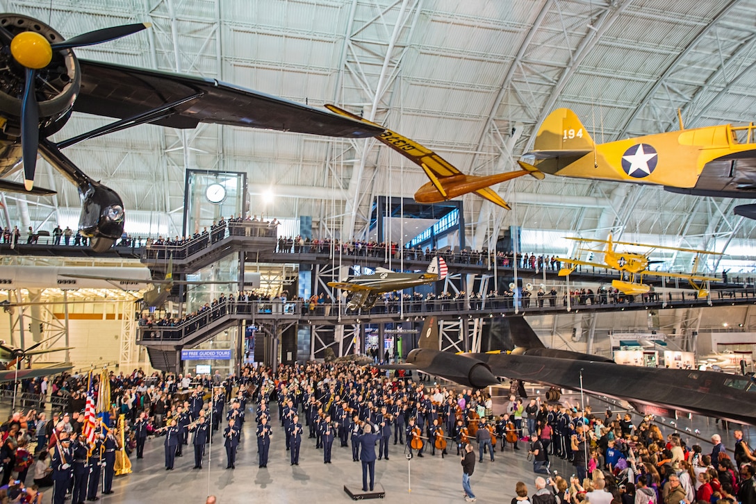 The United States Air Force Band performs a holiday flash mob Dec. 2, 2014, at the Smithsonian National Air and Space Museum Udvar-Hazy Center in Chantilly, Va. The band’s mission is to honor those who have served, inspire American citizens to heightened patriotism and service, and positively impact the global community on behalf of the U.S. Air Force and America. (U.S. Air Force photo/Staff Sgt. Devon Suits)