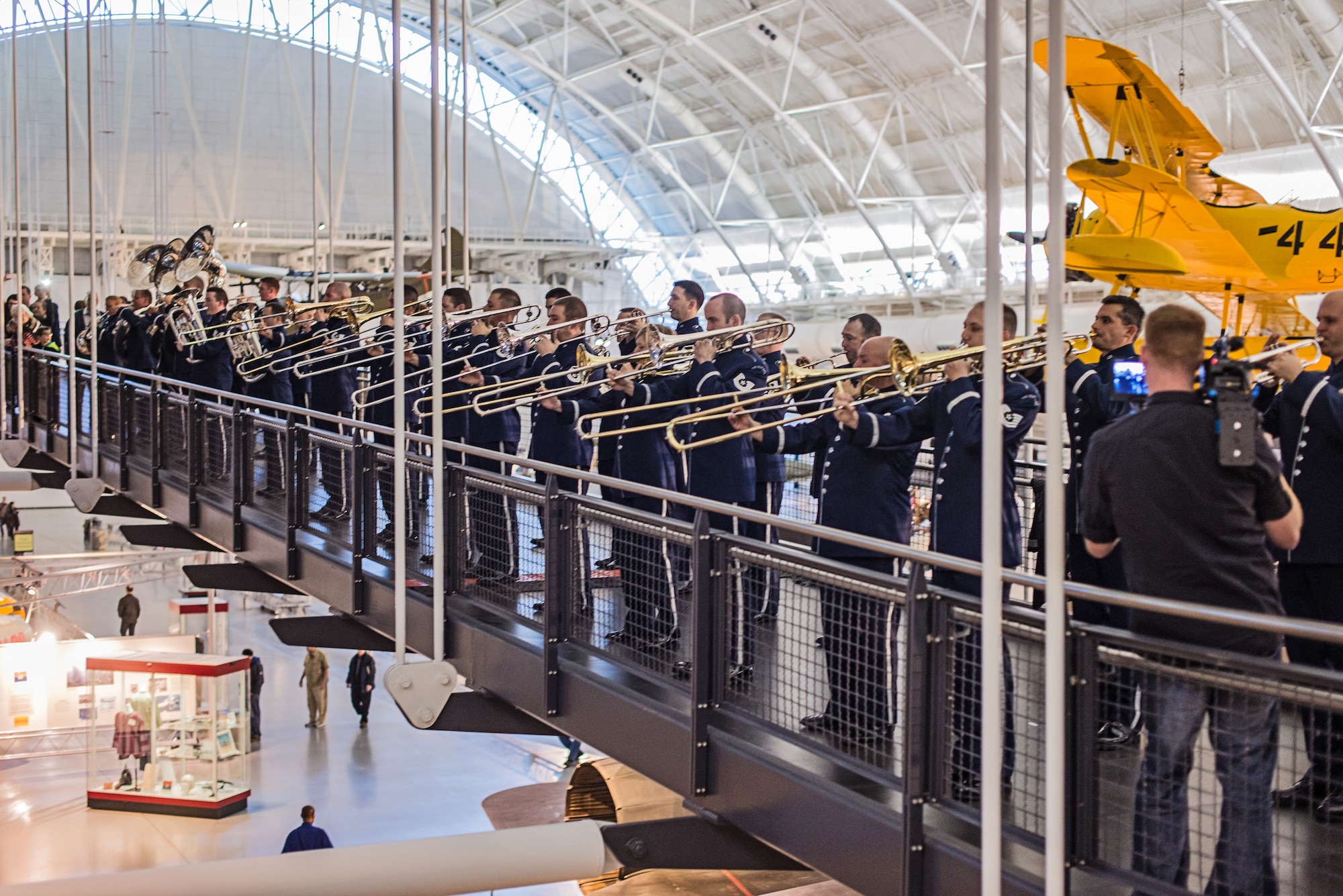 The United States Air Force Band performs a holiday flash mob Dec. 2, 2014, at the Smithsonian National Air and Space Museum Udvar-Hazy Center in Chantilly, Va. The band’s mission is to honor those who have served, inspire American citizens to heightened patriotism and service, and positively impact the global community on behalf of the U.S. Air Force and America. (U.S. Air Force photo/Senior Master Sgt. Kevin
Burns)