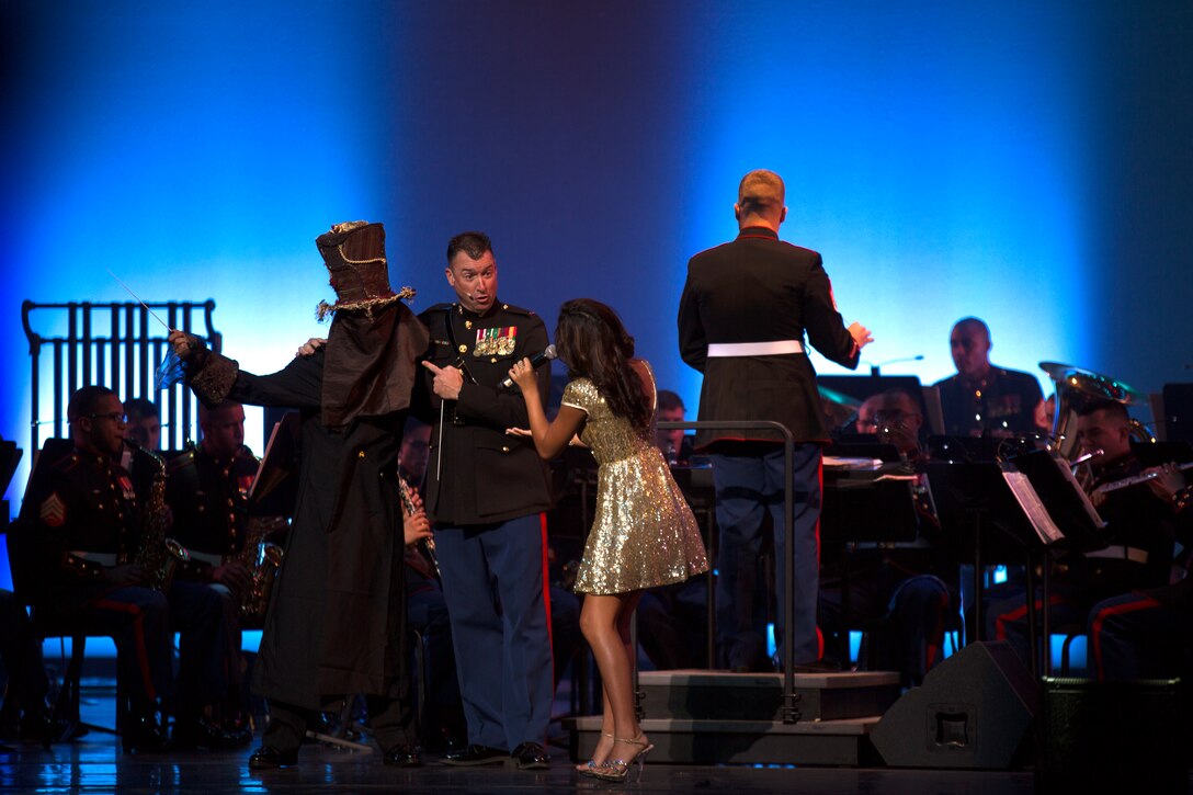 The Ghost of Christmas Past, Chief Warrant Officer 3 Michael J. Smith, band officer of the U.S. Marine Corps Forces, Pacific Band, and Ciana Pelekai perform during the 7th Annual Na Mele o na Keiki (Music for the Children) held at the historic Hawai’i Theatre Center, Nov. 30. This year MARFORPAC helped collect more than 2,000 presents and raise more than $3,200 for Toys for Tots of Hawaii.