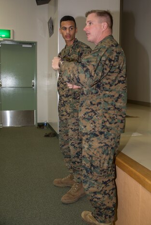 Lt. Col. James Whiteker, Marine Wing Support Squadron 171 commanding officer, expresses his appreciation for Cpl. Tyler L. Saffore, a bulk fuel specialist with MWSS-171, after presenting him with the Bulk Fuel Specialist of the Year award, Dec. 3, 2014, aboard Marine Corps Station Iwakuni, Japan. Saffore won the award for his strong work ethic, initiative and superior performance.