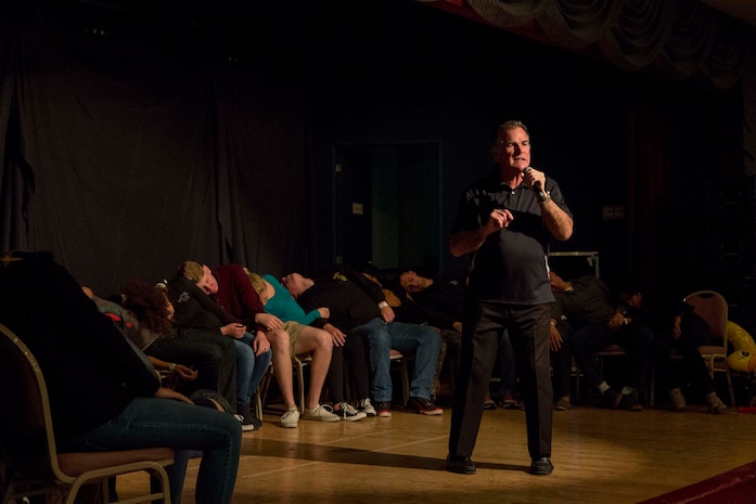 Chuck Milligan, a comedy hypnotist, addresses the audience during his performance inside the Club Iwakuni ballroom, aboard Marine Corps Air Station Iwakuni, Japan, Dec. 1, 2014. Marine Corps Community Services invited Milligan back to MCAS Iwakuni to perform his popular hypnotism show for the 10th consecutive year.