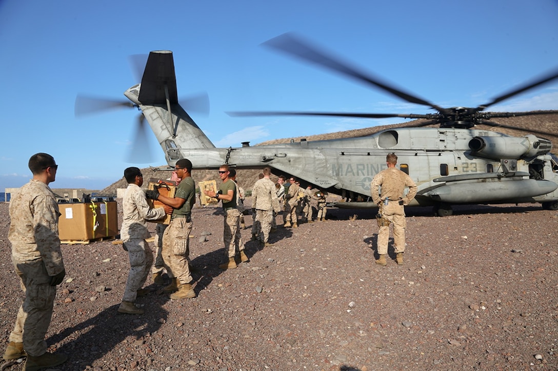 Marines with the 11th Marine Expeditionary Unit (MEU), offload equipment from CH-53E Super Stallion with Marine Medium Tiltrotor Squadron 163 (Reinforced), 11th MEU, during sustainment training in D'Arta Plage, Djibouti, Dec. 1. The Makin Island Amphibious Ready Group (ARG) and the embarked 11th MEU provide a versatile, sea-based, expeditionary force that can be tailored to a variety of missions in the U.S. 5th Fleet area of responsibility. (U.S. Marine Corps photo by Cpl. Laura Y. Raga/ Released)  
