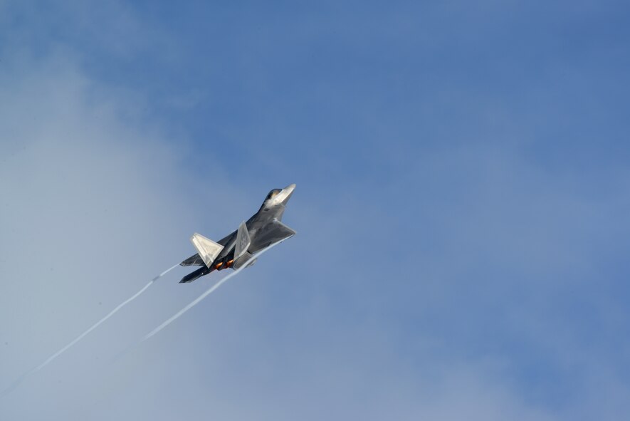 An F-22 Raptor climbs after take-off from the flightline Nov. 24, 2014 at Andersen Air Force Base, Guam. A C-17 Globemaster III along with several F-22s operated from Andersen to practice flexibility in aircraft movement at a non-traditional base with additional pilots, maintenance support and accompanying fuel and munitions. (U.S. Air Force photo by Airman 1st Class Amanda Morris/Released)