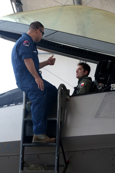 Master Sgt. Shawn Pangborn, 154th Aircraft Maintenance Squadron F-22 Raptor crew chief, and 1st Lt. Jeff Braden, 19th Fighter Squadron pilot from Joint Base Pearl Harbor-Hickam, Hawaii, review the day’s flight Nov. 23, 2014, on Andersen Air Force Base, Guam.  A C-17 Globemaster III along with several F-22s operated from Andersen to practice flexibility in aircraft movement at a non-traditional base with additional pilots, maintenance support and accompanying fuel and munitions. (U.S. Air Force photo by Airman 1st Class Amanda Morris/Released)