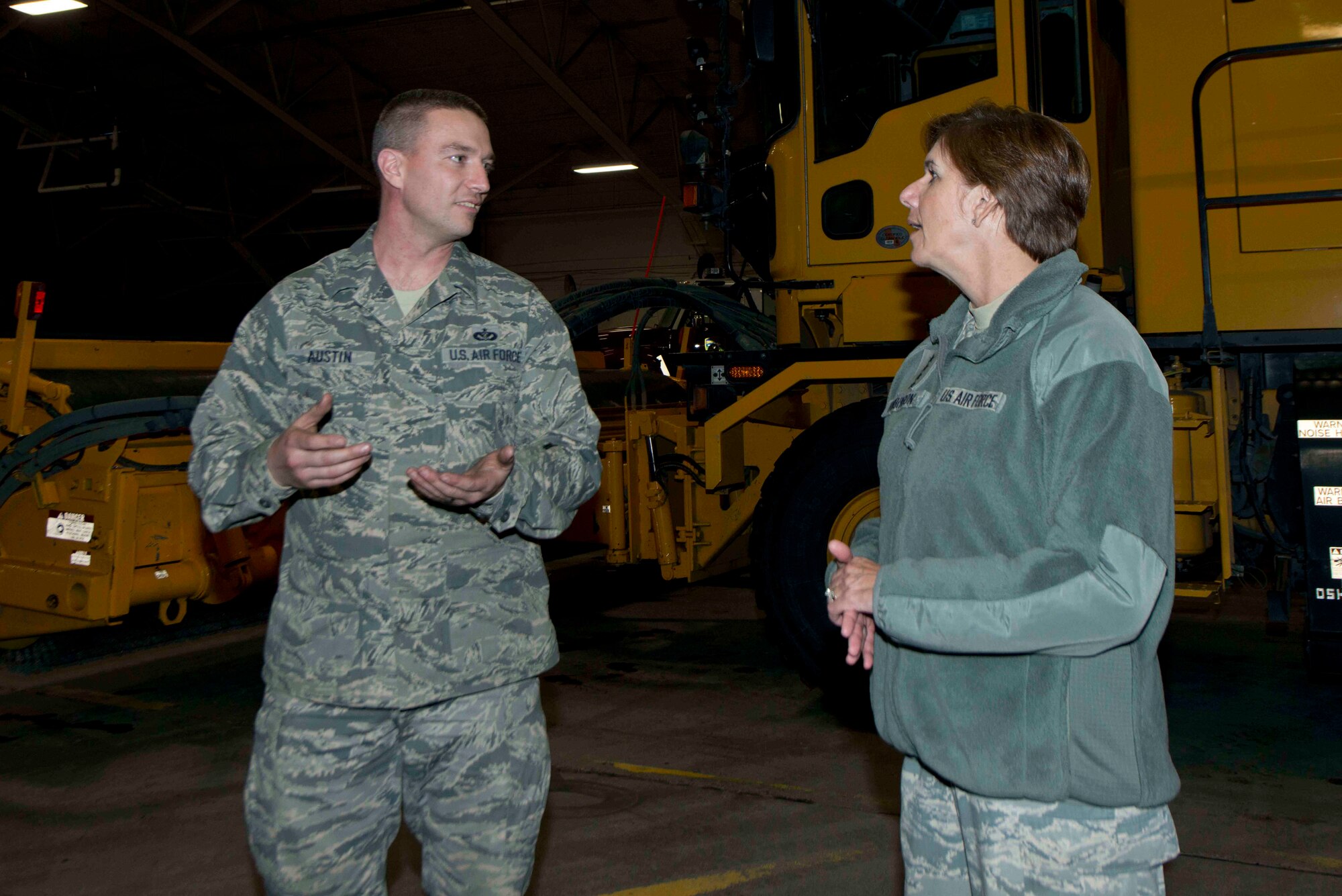 Tech. Sgt. Joseph Austin, 773d Civil Engineer Squadron, speaks to General Lori Robinson, Pacific Air Forces commander, about the Air Force's largest in-house snow removal operations at Joint Base Elmendorf-Richardson, Alaska, Dec. 2, 2014. General Robinson, who assumed command of PACAF in October, visited Airmen and families and witnessed JBER missions and operations during a trip to the base with Chief Master Sgt. Harold Hutchison, PACAF command chief. (U.S. Air Force photo/Staff Sgt. Sheila deVera/RELEASED)