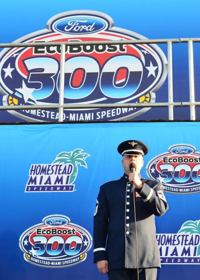 Senior Master Sgt. Ryan Carson, lead vocalist and non-commissioned officer in charge of Max Impact, performs the national anthem before the start of the NASCAR Ford EcoBoost 300 at the Homestead-Miami Speedway on Saturday, Nov. 15.  (U.S. Air Force photo by Senior Master Sgt. Bob Kamholz/released)