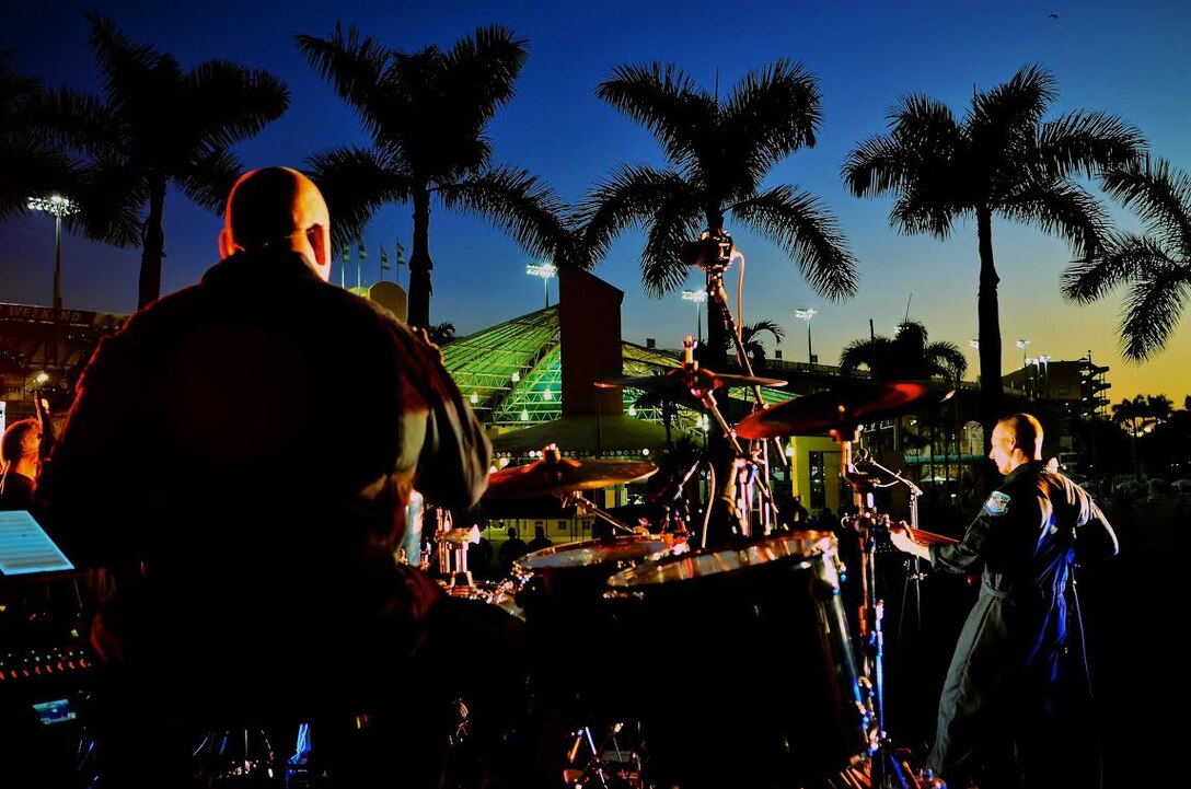 Max Impact members Technical Sgt. Robert Smith and Senior Master Sgt. Matt Ascione perform as the sun sets just prior to the start of the NASCAR Ford EcoBoost 200 on Friday, Nov. 14, at the Homestead-Miami Speedway. (U.S. Air Force photo by Senior Master Sgt. Bob Kamholz/released)