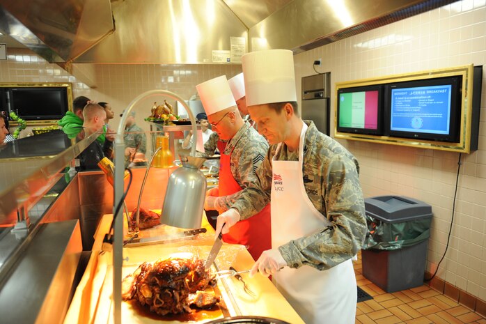 Nellis Air Force Base senior leadership serve Thanksgiving lunch to Airmen at the Crosswinds Inn Dining Facility, Nellis AFB, Nev., Nov. 27, 2014. Senior leaders worked in 30-minute shifts on Thanksgiving day to serve Airmen a Thanksgiving meal. (U.S. Air Force photo by Airman 1st Class Jake Carter)