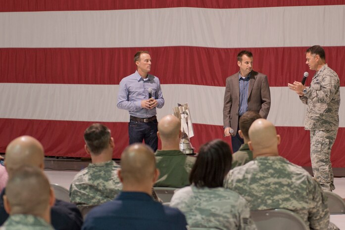 Kevin Harvick (left), 2014 NASCAR Sprint Cup champion, and his crew chief, Rodney Childers, speak with Col. Richard Boutwell, 99th Air Base Wing commander, after taking questions from Nellis Airmen during their visit to Nellis Air Force Base, Nev., at the Thunderbirds hangar Dec. 2, 2014. Harvick visited the base on his championship tour to thank service members and meet military fans. (U.S. Air Force photo by Staff Sgt. Victoria Sneed)