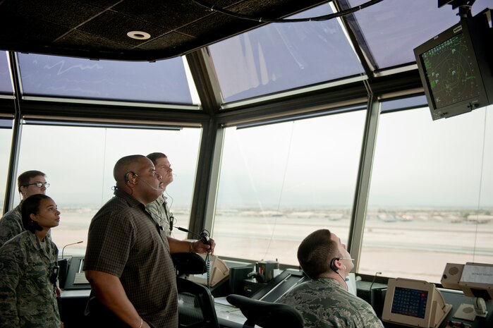 Airmen from the 57th Operations Support Squadron monitor aircraft flying through Nellis Air Force Base airspace, in the control tower at Nellis AFB, Nev., Dec. 2, 2014. The control tower is responsible for managing aircraft flying through Nellis airspace. (U.S. Air Force photo by Airman 1st Class Mikaley Towle)
