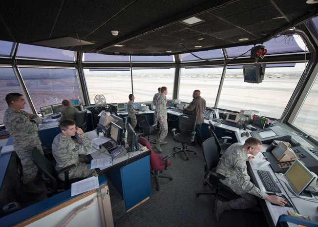 Airmen from the 57th Operations Support Squadron conduct operations in the control tower at Nellis Air Force Base, Nev., Dec. 2, 2014. The Nellis AFB control tower coordinates with control towers from McCarran International Airport and North Las Vegas Airport to help with transitioning aircraft. (U.S. Air Force photo by Airman 1st Class Mikaley Towle)