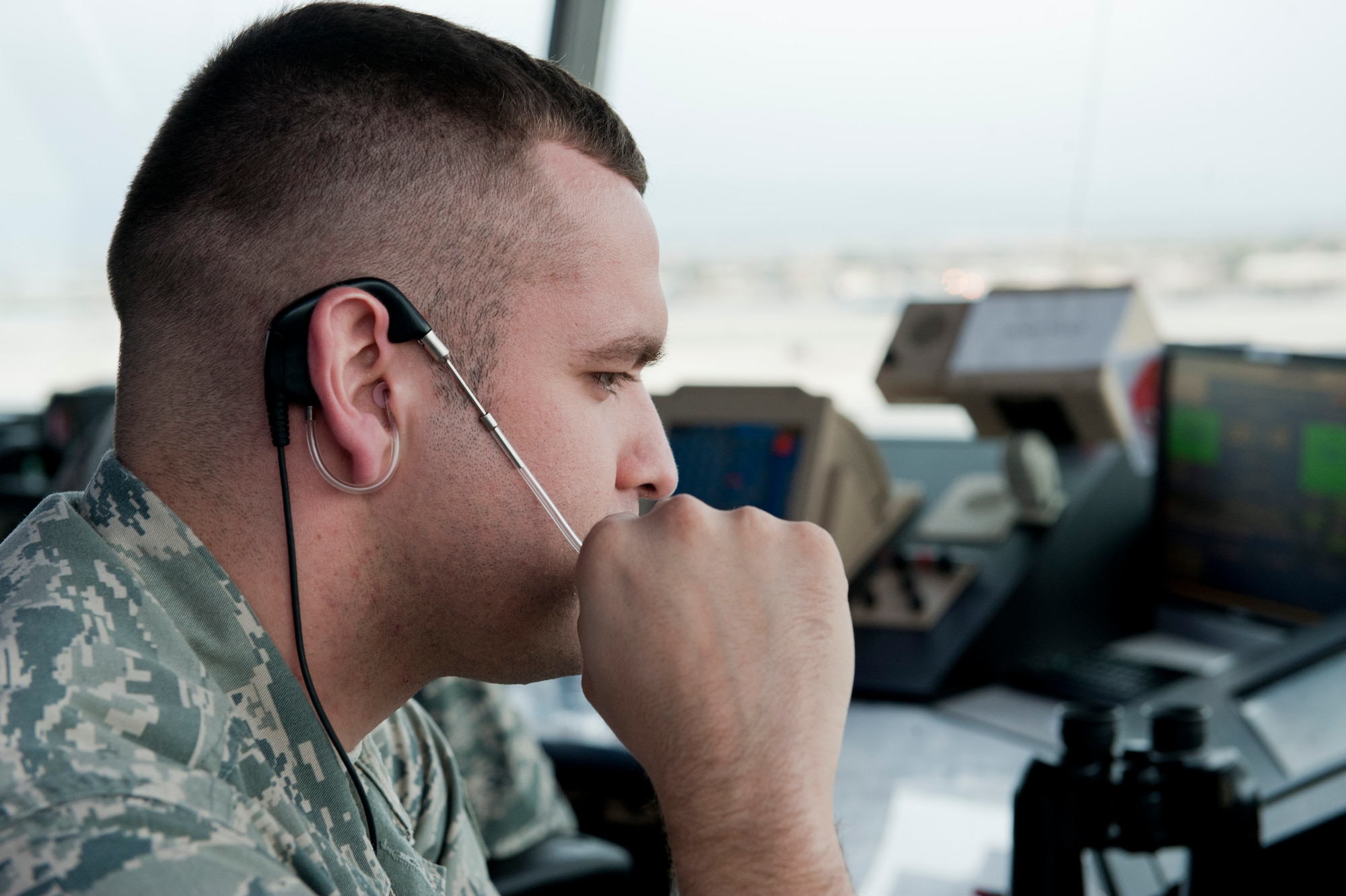 Staff Sgt. Martin Figueroa, 57th Operations Support Squadron tower air traffic controller, relays cloud height information to the 57th OSS weather center in the control tower at Nellis Air Force Base, Nev., Dec 2, 2014. In addition to controlling the airspace over Nellis AFB, the control tower is responsible for managing every arriving and departing aircraft from the base. (U.S. Air Force photo by Senior Airman Thomas Spangler) 