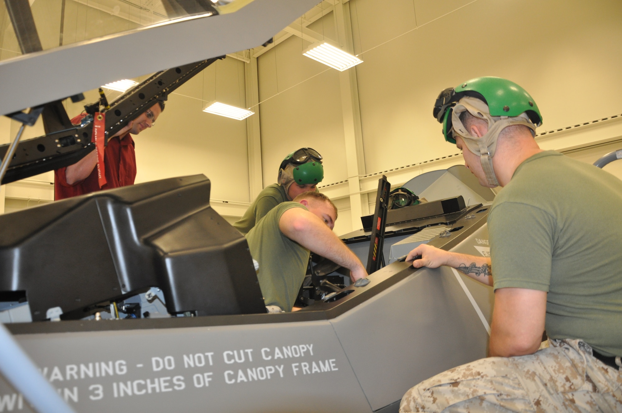 U.S. Marine Corps F-35 Lightning II maintainer students train at the ejection seat maintenance trainer at the 33rd Fighter Wing’s F-35 Academic Training Center on Eglin Air Force Base, Fla., Sept. 9, 2012. The pilot and maintainer qualifications are accomplished through simulations to ensure efficient mission readiness. As the first of its kind in the Department of Defense, the wing is responsible for F-35 Lightning II pilot and maintainer training for the DOD and, in the future, at least eight coalition partners. (U.S. Air Force courtesy photo)