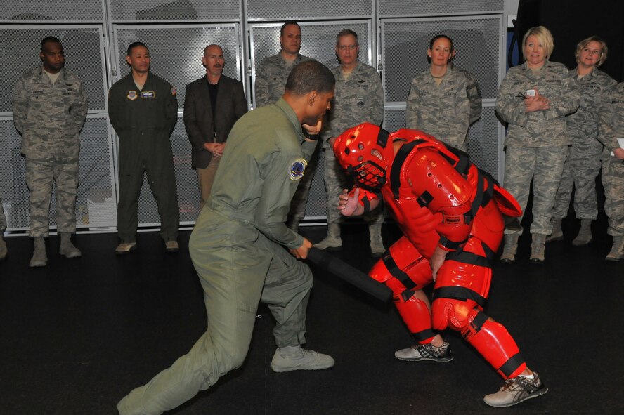 Tech. Sgt. Scott Benford Jr. and Staff Sgt. Andres Emayo, both of the 421st Combat Training Squadron’s Phoenix Raven course, demonstrate gaining and maintaining control during apprehension of an adversary at the U.S. Air Force Expeditionary Center December 2, 2014. Visitors from Air Mobility Command received briefings, witnessed demonstrations, and participated in an open forum during the visit.(U.S. Air Force Photo/ Brad Camara)