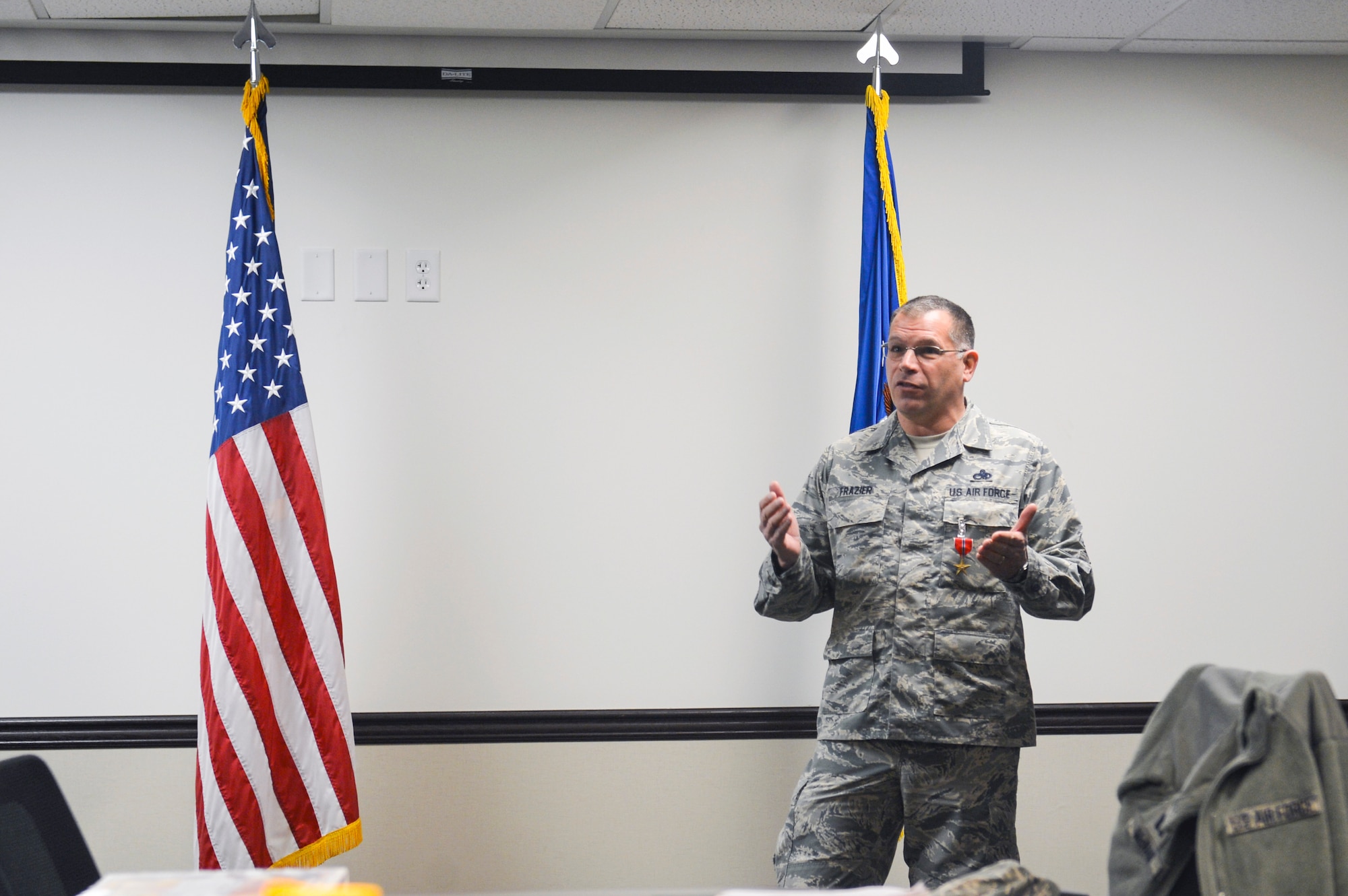 Chief Master Sgt. John Frazier, 62nd Maintenance Group superintendent, thanks members of an audience for attending the presentation of his Bronze Star reception during an award ceremony Dec. 3, 2014, at Joint Base Lewis-McChord, Wash. Squadron commanders, senior enlisted leaders, maintenance Airmen, civilians and family members joined together during the ceremony to recognize Frazier’s accomplishments and applaud his reception of the medal. (U.S. Air Force photo/Staff Sgt. Russ Jackson)