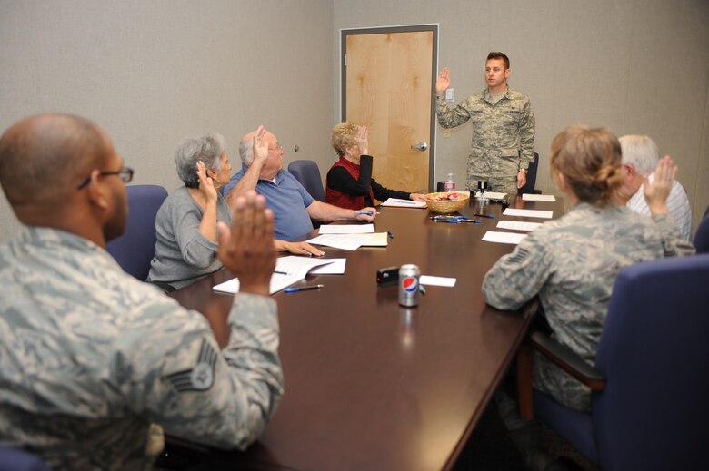 U.S. Air Force Capt. Nelson Faerber III, 355th Fighter Wing assistant judge advocate, swears in retirees and witnesses before finalizing their wills on Davis-Monthan Air Force Base, Ariz., Nov. 19, 2014. The legal office now offers Retiree Will Nights monthly instead of once a quarter. (U.S. Air Force photo by Staff Sgt. Courtney Richardson)