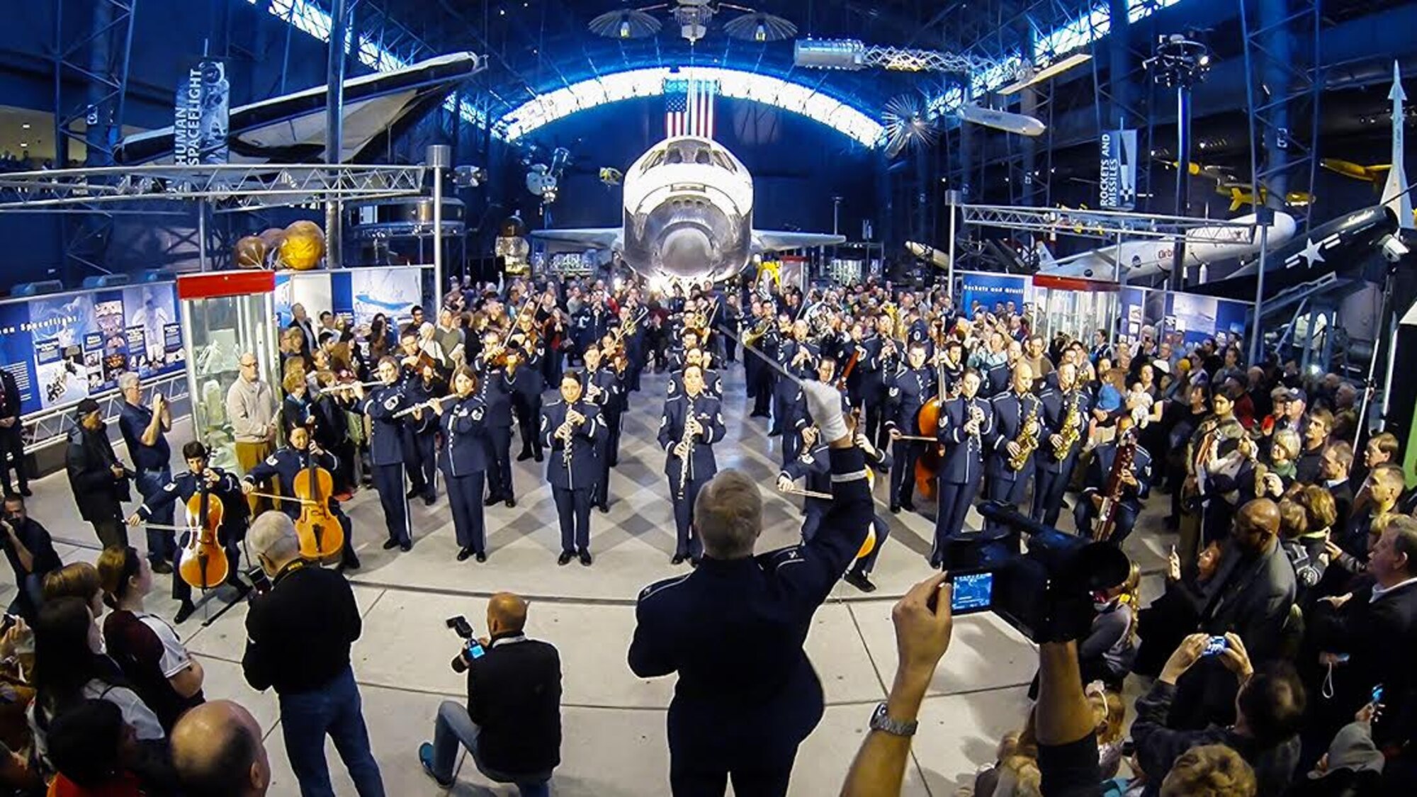 The United States Air Force Band performs a holiday flash mob Dec. 2, 2014, at the Smithsonian National Air and Space Museum Udvar-Hazy Center in Chantilly, Va. The band’s mission is to honor those who have served, inspire American citizens to heightened patriotism and service, and positively impact the global community on behalf of the U.S. Air Force and America. (U.S. Air Force photo by Staff Sgt. Devon Suits/Released)