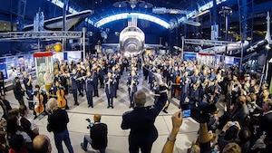 The United States Air Force Band performs a holiday flash mob Dec. 2, 2014, at the Smithsonian National Air and Space Museum Udvar-Hazy Center in Chantilly, Va. The band’s mission is to honor those who have served, inspire American citizens to heightened patriotism and service, and positively impact the global community on behalf of the U.S. Air Force and America. (U.S. Air Force photo by Staff Sgt. Devon Suits/Released)