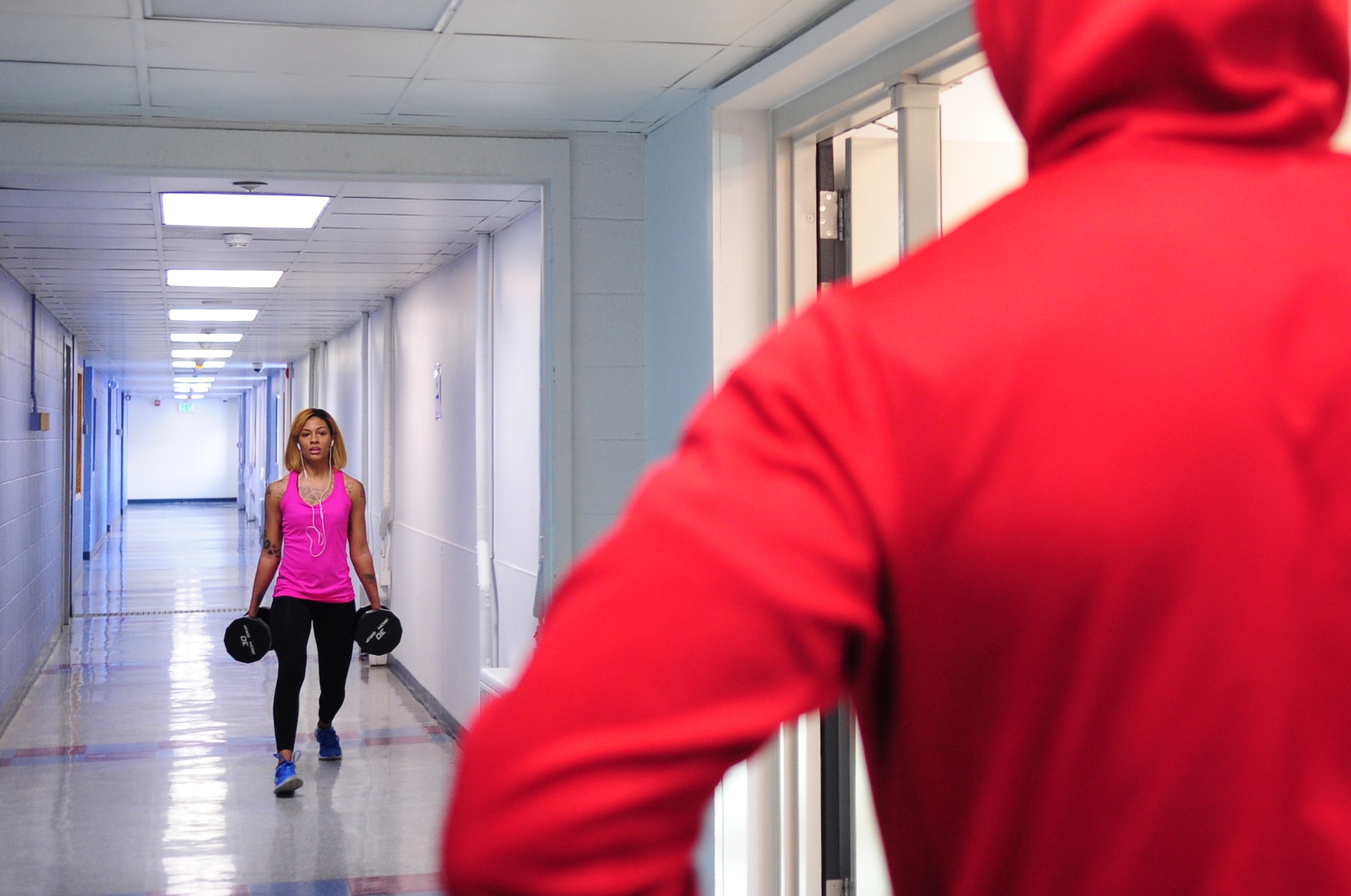 U.S. Air Force Senior Airman Kati Lappin, a 354th Medical Support Squadron dental technician, preforms lunges during a training session with her trainer Jean Paul Williams at the Baker Field House on Nov. 8, 2014, Eielson Air Force Base, Alaska. The week before Lappin’s second competition came up she went to the gym every day for about two to three hours. (U.S. Air Force photo by Senior Airman Lauren-Taylor Levin/Released)