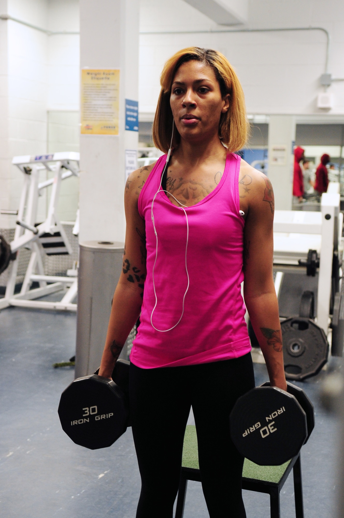 U.S. Air Force Senior Airman Kati Lappin, a 354th Medical Support Squadron dental technician, preforms shoulder shrugs during a training session at the Baker Field House on Nov. 8, 2014, Eielson Air Force Base, Alaska. The week before Lappin’s second competition came up she went to the gym every day for about two to three hours. (U.S. Air Force photo by Senior Airman Lauren-Taylor Levin/Released)