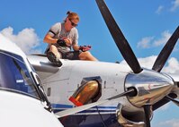 Tech. Sgt. Michele Sturm, a 919th Special Operations Aircraft Maintenance Squadron crew chief, checks a C-145's engine oil during a post-flight inspection at Duke Field, Fla. The SOAMXS helps ensure airworthiness of Duke's fleet as it supports special operations combatant commanders worldwide. (U.S. Air Force photo/Dan Neely)