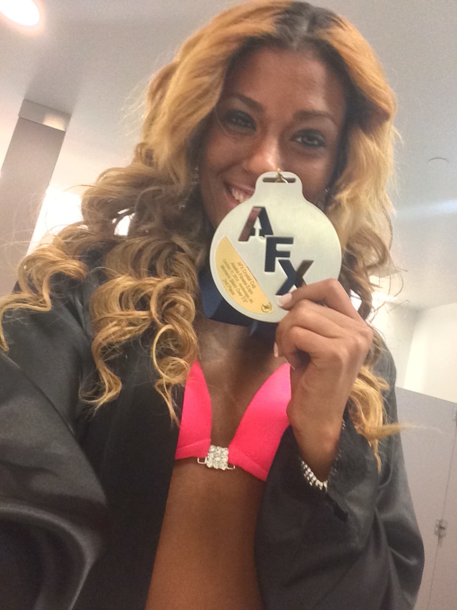 U.S. Air Force Senior Airman Kati Lappin, a 354th Medical Support Squadron dental technician, shows her second place medal at the Alaska Fitness Expo held in Anchorage, Oct. 12, 2014. This was the first bikini fitness model competition Lappin has participated in. (Courtesy photo by Senior Airman Kati Lappin/Released)