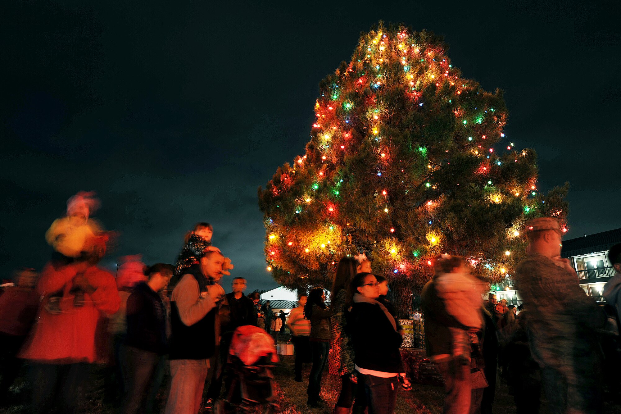 GOODFELLOW AIR FORCE BASE, Texas – Goodfellow members gather around the Holiday Tree during the tree lighting ceremony near the Taylor Chapel Dec. 2. The Taylor Chapel invited all base personnel and their families to the ceremony to celebrate in holiday spirit. (U.S. Air Force photo/ Airman 1st Class Devin Boyer)
