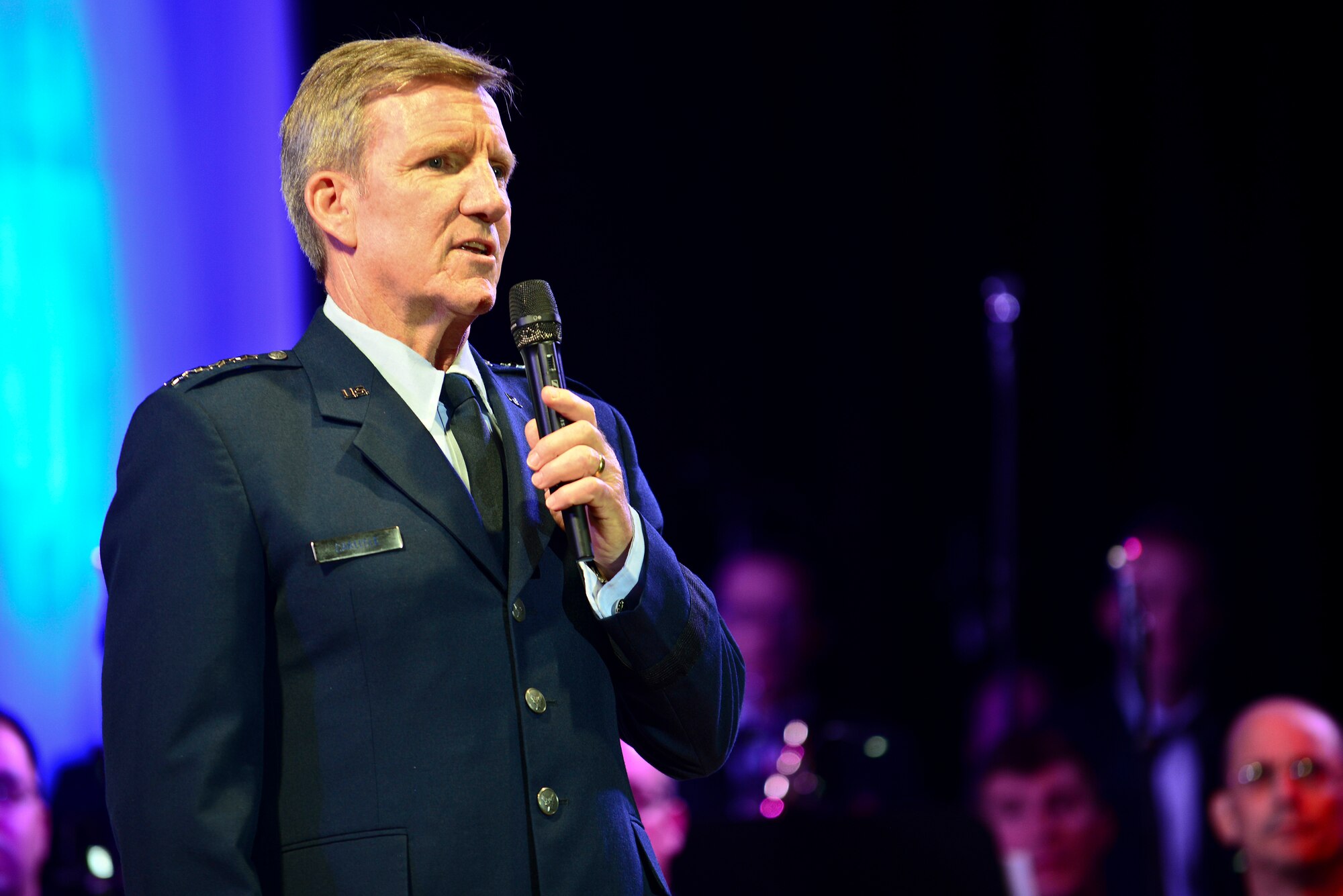 U.S. Air Force Gen. Hawk Carlisle, Air Combat Command commander, spoke to audience members at the U.S. Air Force Heritage of America Band’s “Through Children’s Eyes” holiday concert at Jamestown High School in Williamsburg, Va., Dec. 2, 2014. Carlisle was joined by Chief Master Sgt. Steve McDonald, ACC command chief, and their family members. (U.S. Air Force photo by Senior Airman Kimberly Nagle/Released)