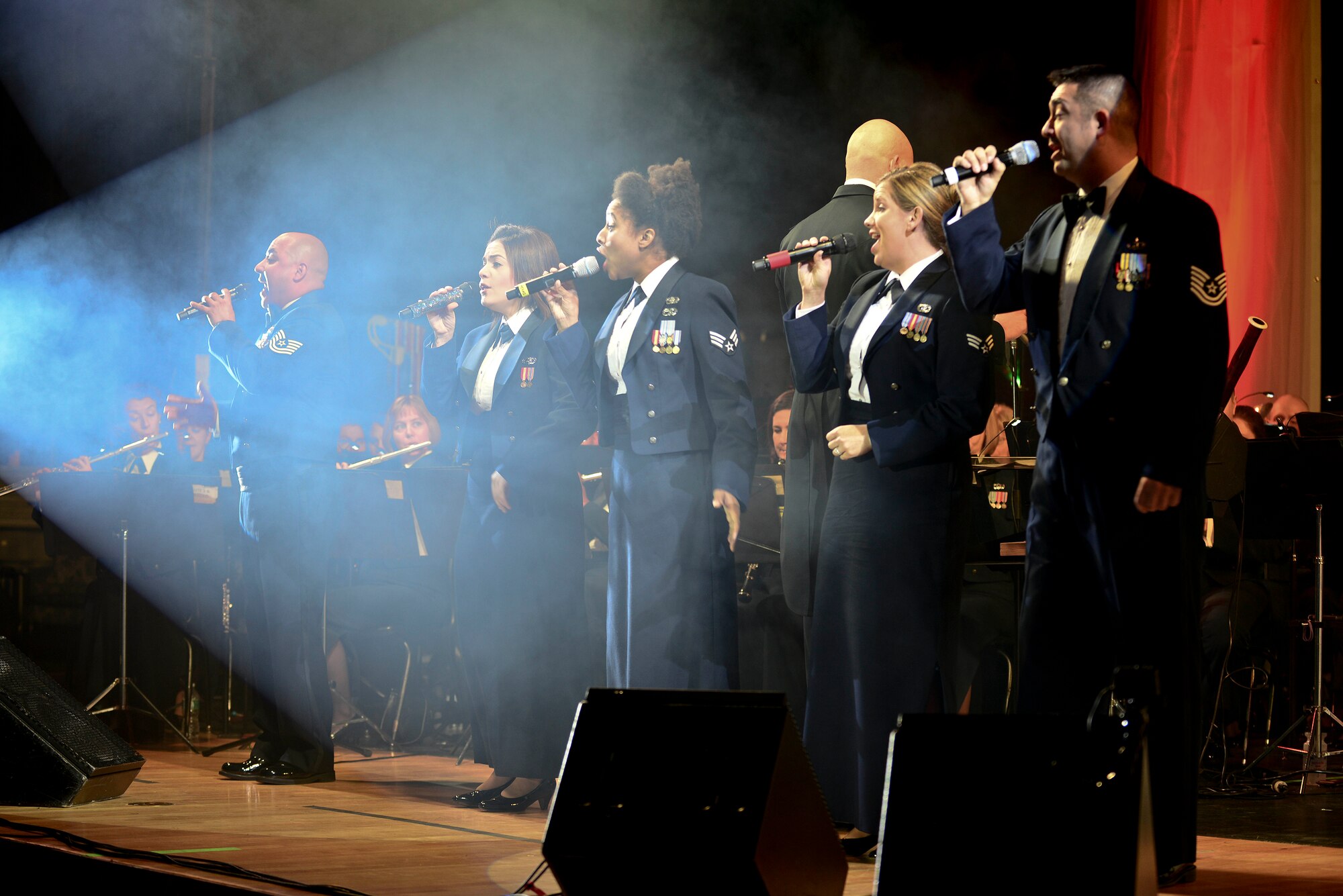 U.S. Air Force vocalists from the U.S. Air Force Heritage of America Band perform during their holiday concert “Through Children’s Eyes” at Jamestown High School in Williamsburg, Va., Dec. 2, 2014. The vocalists encouraged the audience members to sing along with them throughout the performance. (U.S. Air Force photo by Senior Airman Kimberly Nagle/Released)