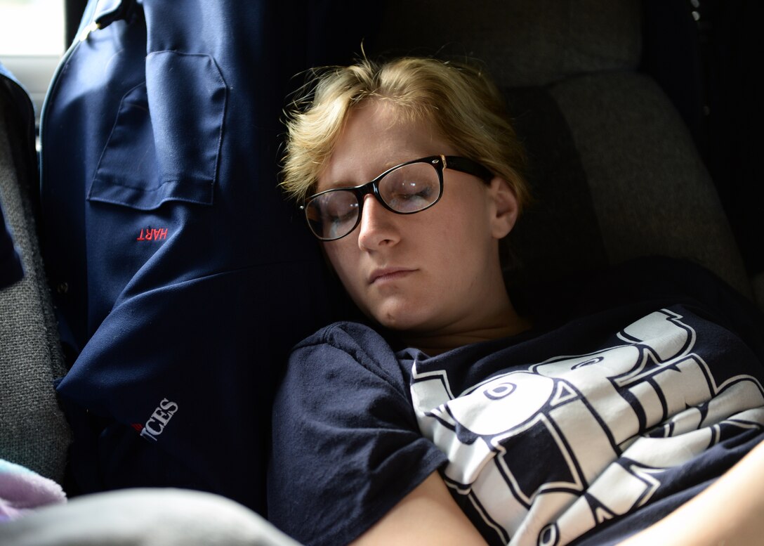 First Lt. Shannon Hart, 614th Air and Space Operations Squadron Space and Missile Operations officer and Tops in Blue keyboardist, sleeps during the drive from Lackland Air Force Base, Texas to Keesler AFB, Miss. Oct. 31, 2014. Due to long days, consisting of close quarters, rehearsals, set-ups, performances, etc., members sleep when the opportunity is available. (U.S. Air Force photo by Airman 1st Class Jimmie D. Pike)(Released)