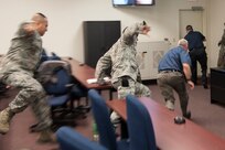 Left to right: Master Sgt. David Colon, Air Education and Training Command Inspector General Directorate; Master Sgt. Kerry Thompson, 502nd Air Base Wing Inspector General Office NCO in charge of inspections; Frank Hawley, 502nd ABW IG self assessment program manager; and Michael Broeker, 502nd ABW IG wing inspection team manager, run towards an exit during a Counter Active Shooter Tactics training scenario Nov. 4 at Joint Base San Antonio-Randolph. (U.S. Air Force photo by Airman 1st Class Stormy Archer)