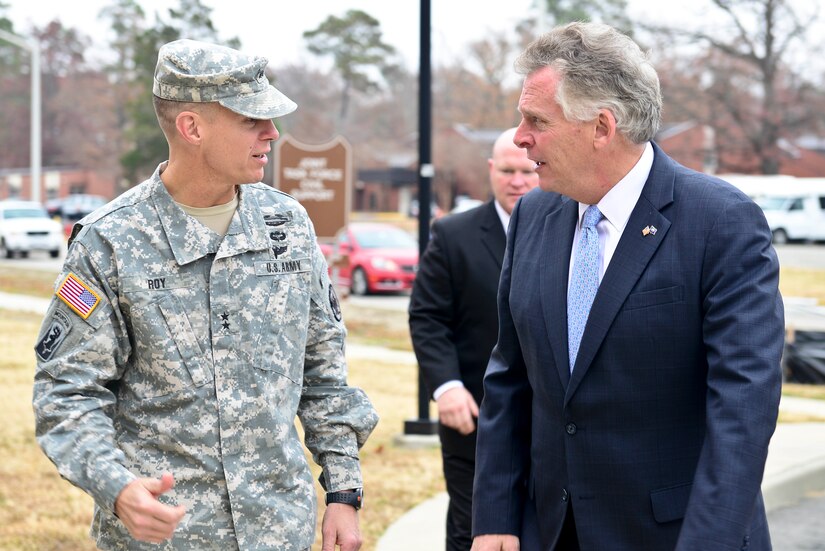 U.S. Army Major Gen. William Roy, Joint Task Force Civil Support commander, greets Terry McAuliffe, Virginia governor, as part of the governor’s visit at Fort Eustis, Va., Dec. 2, 2014. During his tour, the governor visited the U.S. Army Training and Doctrine Command Headquarters as well as 3rd port to interact with Soldiers from the 7th Transportation Brigade (Expeditionary) and the 597th Transportation Brigade. (U.S. Air Force photo by Senior Airman Kimberly Nagle/Released)