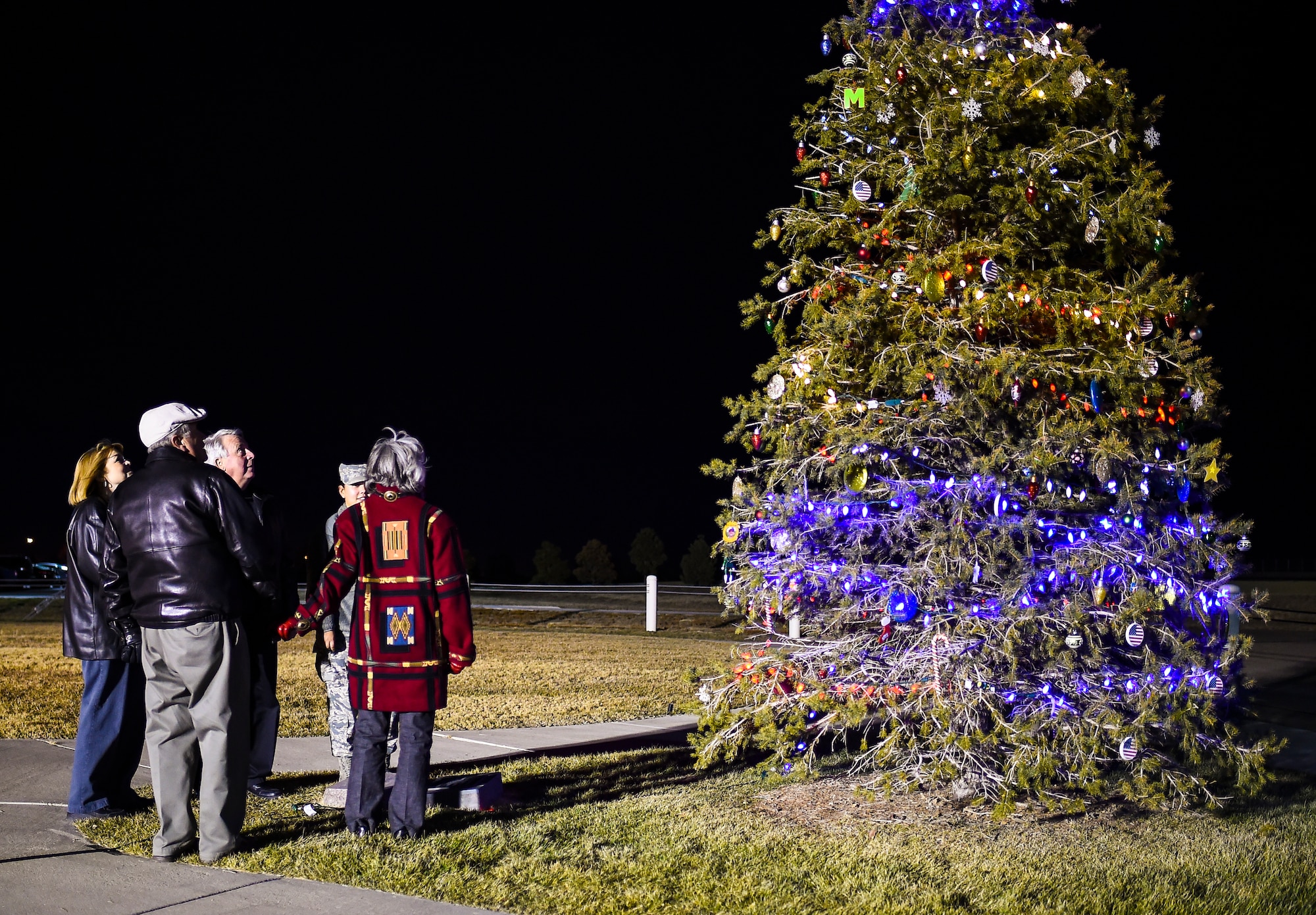 Family members of the late Senior Airman Kristopher Mansfield light the tree in honor of Kristopher Dec. 2, 2014, on Buckley Air Force Base, Colo. The tree-lighting ceremony honored Kristopher and Senior Airman Michael Snyder, both members of the 460th Space Communications Squadron who were killed by drunk drivers. (U.S. Air Force photo by Senior Airman Riley Johnson/Released)