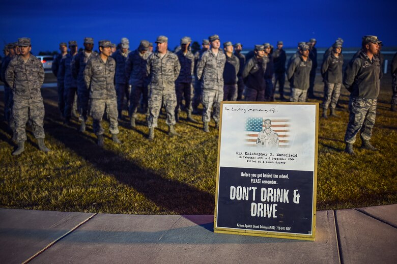 Members of the 460th Space Communications Squadron gather for a tree-lighting ceremony Dec. 2, 2014, on Buckley Air Force Base, Colo. The ceremony honored Senior Airman Kristopher Mansfield and Senior Airman Michael Snyder, both members of the 460th SCS who were killed by drunk drivers. (U.S. Air Force photo by Senior Airman Riley Johnson/Released)